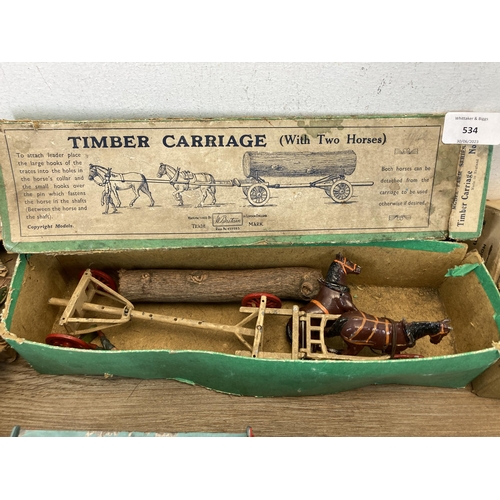 534 - A collection of boxed Britains hand painted lead horse and carriage figures together with a Charbens... 