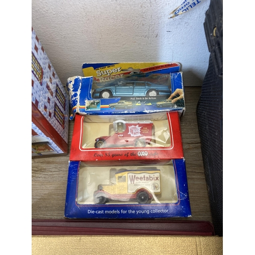 590 - A collection of items to include three die-cast model vehicles, books, Jack Daniels tin, Guernsey Fi... 