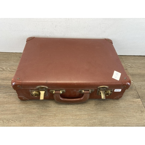 592 - A vintage brown leather suitcase containing antique and vintage worldwide stamps, cigarette cards an... 