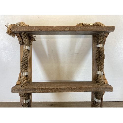 596 - A reclaimed wood and rope three tier wall hanging shelf - approx. 68cm high x 53cm wide