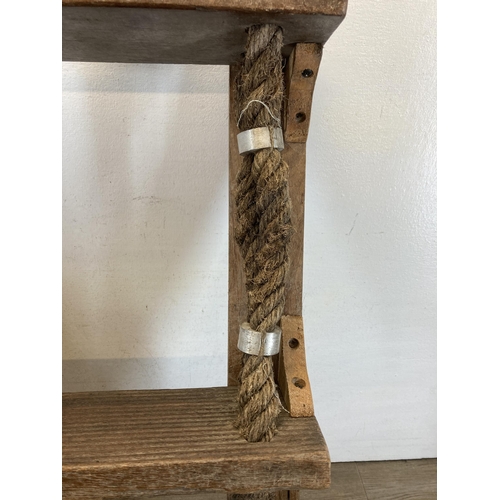 596 - A reclaimed wood and rope three tier wall hanging shelf - approx. 68cm high x 53cm wide