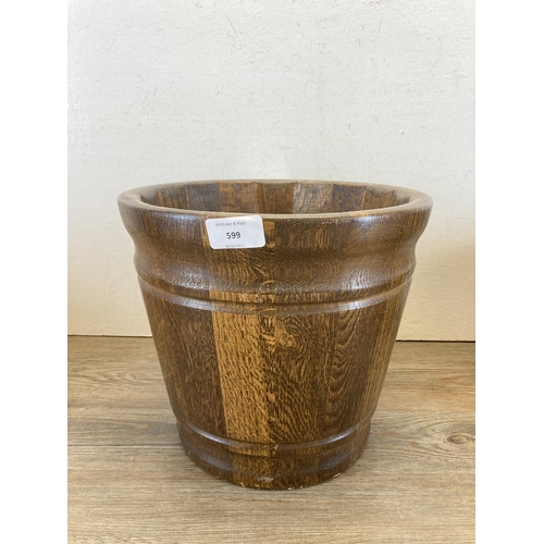 599 - Three oak jardinières - largest approx. 25cm high x 28cm diameter