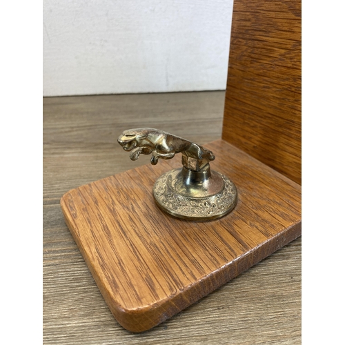 601 - A pair of oak and cast metal Jaguar mascot bookends - approx. 14cm high x 10cm wide x 15cm long