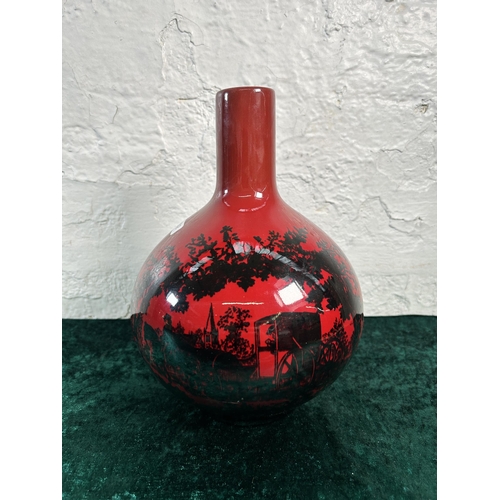 321 - A Royal Doulton Flambé Woodcut no. 1618 bottle neck vase - approx. 24cm high