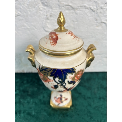 323 - A Coalport Hong Kong twin handled urn and cover - approx. 17.5cm high