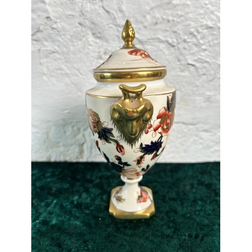 323 - A Coalport Hong Kong twin handled urn and cover - approx. 17.5cm high