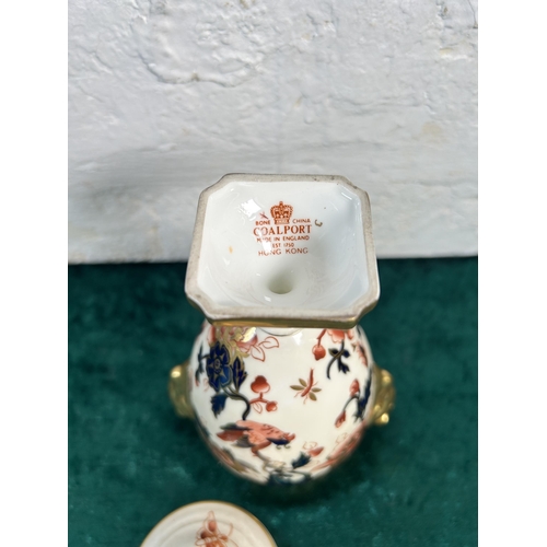 323 - A Coalport Hong Kong twin handled urn and cover - approx. 17.5cm high