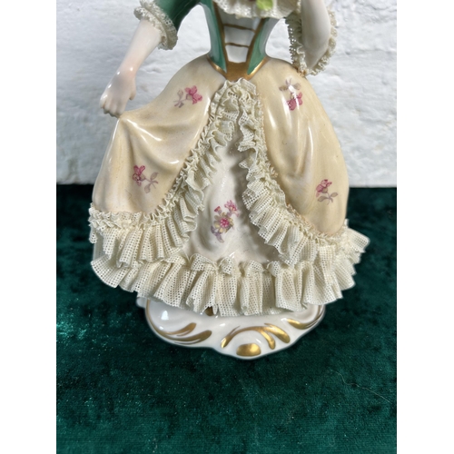 343 - A Dresden hand painted lace porcelain lady figurine, numbered 527 - approx. 17cm high