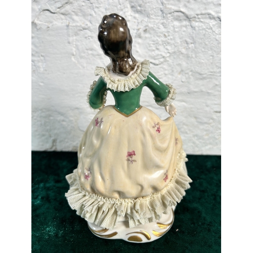 343 - A Dresden hand painted lace porcelain lady figurine, numbered 527 - approx. 17cm high