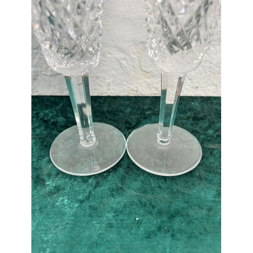 348 - Three pieces of glassware, two Waterford champagne flutes and one Stuart jug