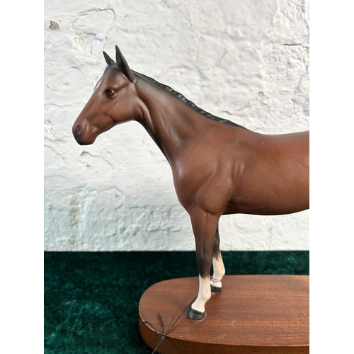 368 - A Royal Doulton matt brown horse figurine on mahogany plinth - approx. 22cm high x 28cm long