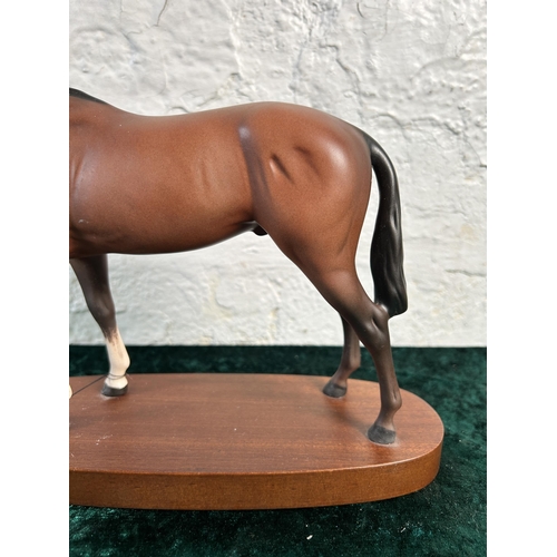 368 - A Royal Doulton matt brown horse figurine on mahogany plinth - approx. 22cm high x 28cm long