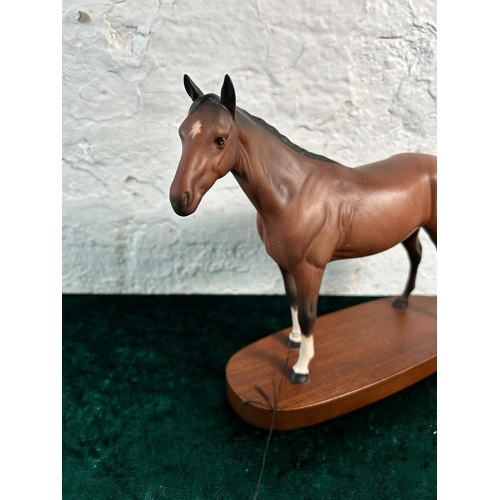 368 - A Royal Doulton matt brown horse figurine on mahogany plinth - approx. 22cm high x 28cm long