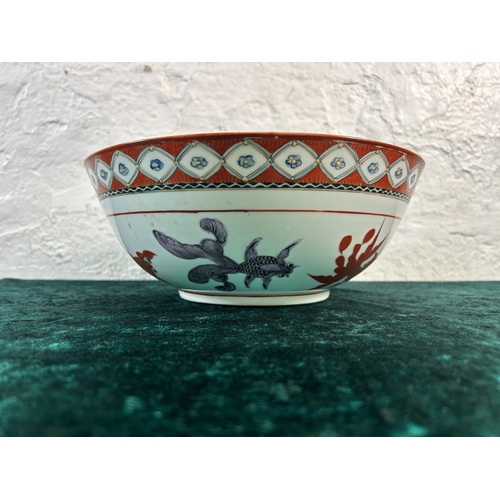 373 - An Oriental gold fish pattern porcelain circular footed bowl - approx. 26cm diameter