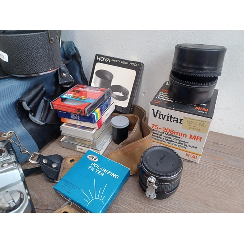 686 - A large collection of optical and camera equipment to include Nikon Nikomat EL 35mm SLR camera fitte... 