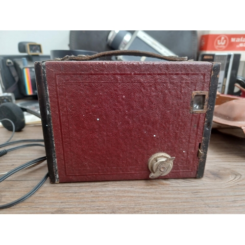 692 - A collection of items to include dark red Kodak Brownie No.2 box camera for 120 film, two cased Fuji... 