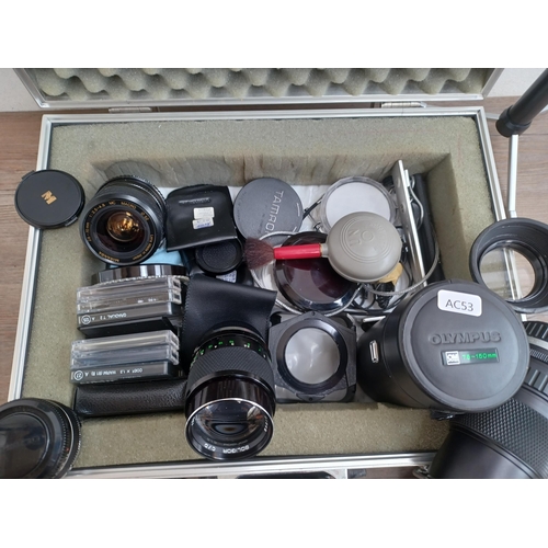 693 - An aluminium flight case containing a collection of Olympus and OM system compatible items to includ... 