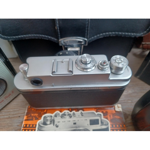 694 - A collection of cameras and photography equipment to include cased KMZ Zenit TTL 35mm SLR camera wit... 