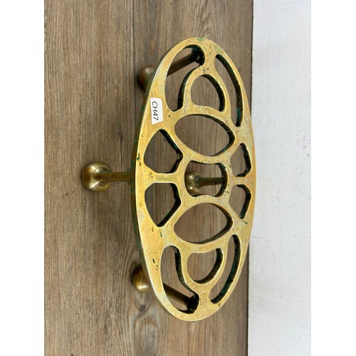 503A - A 19th century brass trivet stand - approx. 13cm high x 29cm wide x 18cm deep