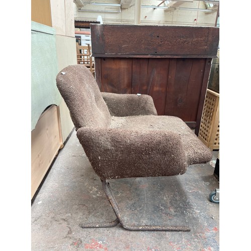 238A - A mid 20th century brown fabric upholstered armchair on tubular metal supports