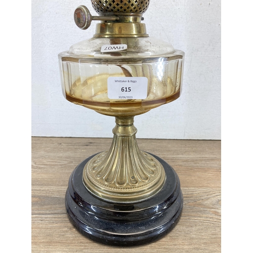 615 - A T. Rowatt & Sons brass oil lamp with black ceramic base, amber glass reservoir and glass shade - a... 