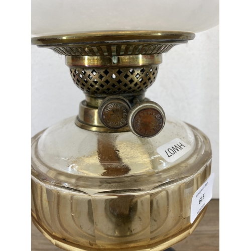 615 - A T. Rowatt & Sons brass oil lamp with black ceramic base, amber glass reservoir and glass shade - a... 