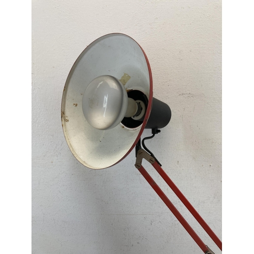 620 - An Anglepoise style red metal articulated desk lamp