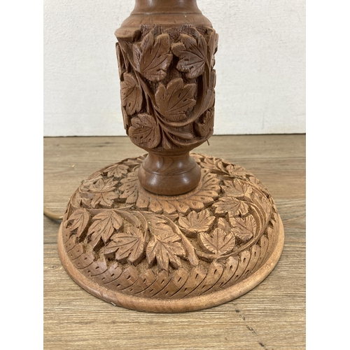 625 - A carved teak table lamp - approx. 50cm high