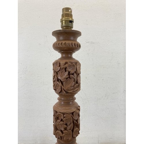 625 - A carved teak table lamp - approx. 50cm high