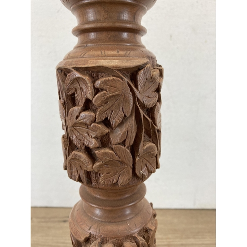 625 - A carved teak table lamp - approx. 50cm high