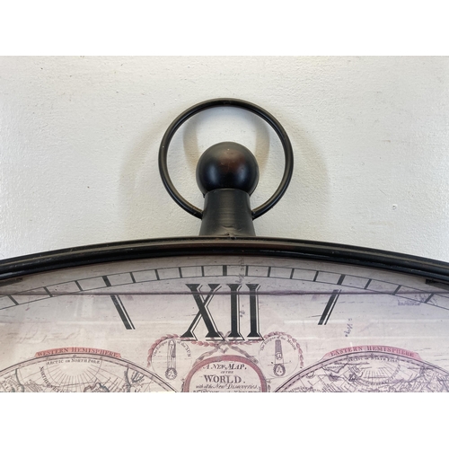 626 - A Victorian style black metal cased map of the world wall clock - approx. 68cm high x 67cm wide