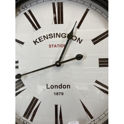 627 - A Victorian style Kensington Station London black metal cased wall clock - approx. 71cm high x 59cm ... 