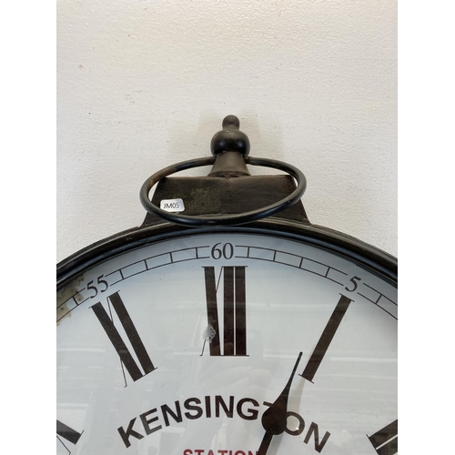 627 - A Victorian style Kensington Station London black metal cased wall clock - approx. 71cm high x 59cm ... 