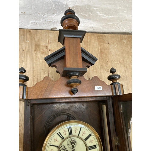 640 - A Victorian walnut cased Vienna wall clock with pendulum and weights - approx. 128cm high x 40cm wid... 