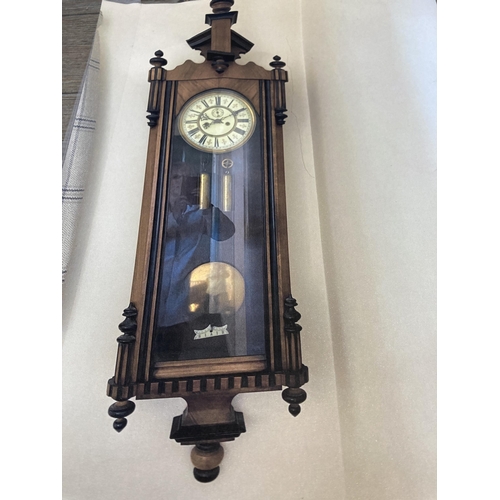 640 - A Victorian walnut cased Vienna wall clock with pendulum and weights - approx. 128cm high x 40cm wid... 