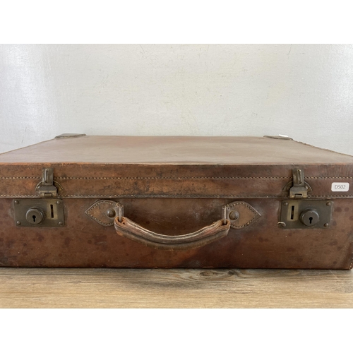 640B - An early 20th century brown leather suitcase - approx. 18cm high x 61cm wide x 39cm deep