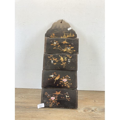 646 - An Oriental hand painted and black lacquered wall hanging letter rack - approx. 55cm high