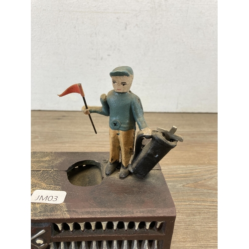 658 - A hand painted cast metal novelty golfing money box - approx. 16cm high x 21cm wide x 8cm deep