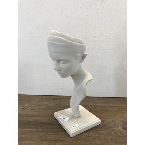 662 - A ceramic lady sculpture on plinth - approx. 31cm high