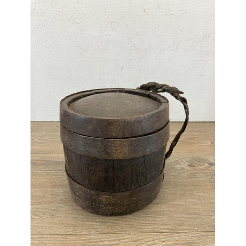 664 - A 19th century oak and iron banded costrel/harvest barrel - approx. 20cm high x 16cm wide x 16cm dee... 