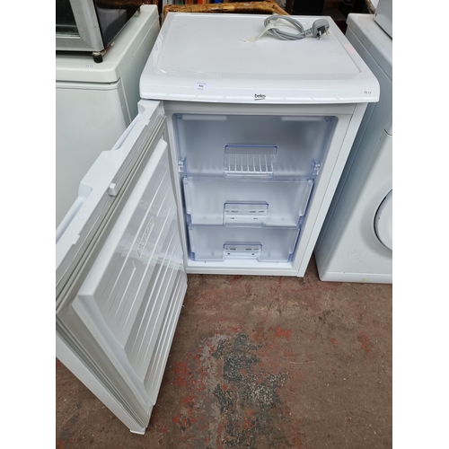 833 - A Beko 55cm under counter freezer