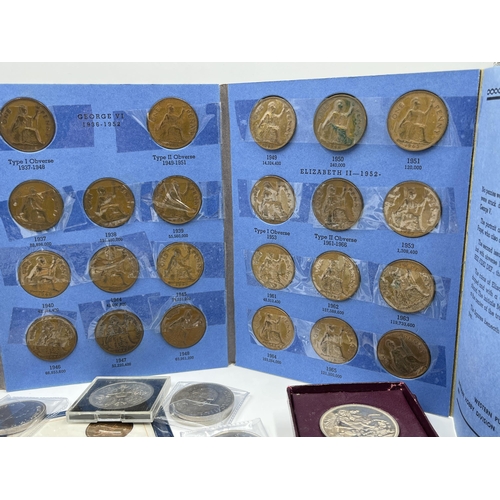 2267 - A cash tin containing a collection of coin sets and commemorative coins to include two 2002 and one ... 