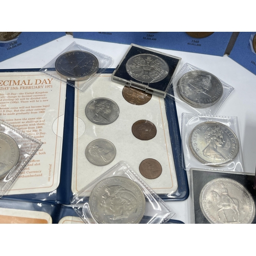 2267 - A cash tin containing a collection of coin sets and commemorative coins to include two 2002 and one ... 