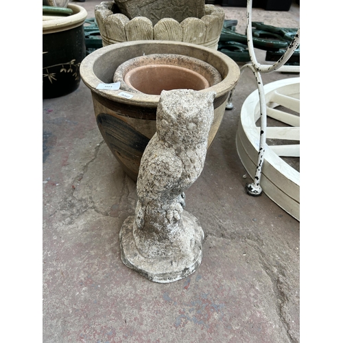 1015 - A collection of garden items to include cast stone owl ornament, cast stone barrel planter etc.