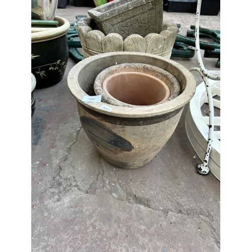 1015 - A collection of garden items to include cast stone owl ornament, cast stone barrel planter etc.