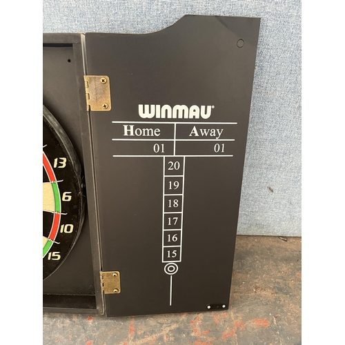 859 - A cased Winmau dartboard