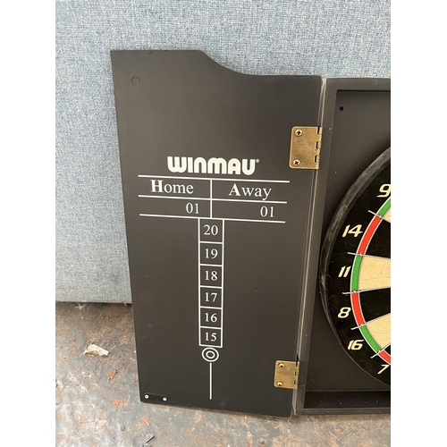 859 - A cased Winmau dartboard