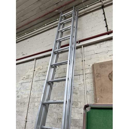 870 - A pair of Clima aluminium extending ladders