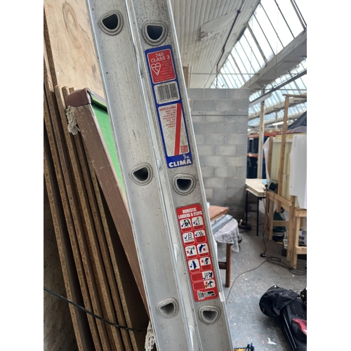 870 - A pair of Clima aluminium extending ladders