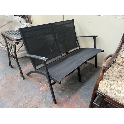 881 - A metal folding two seater garden bench